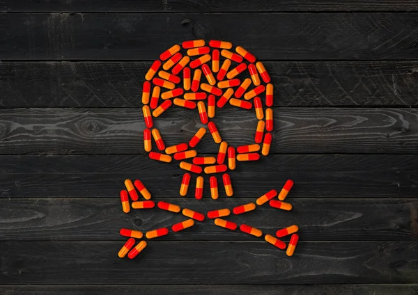 Skull Made Orange Capsule Pills Isolated Black Wood Background Illustration — Stock Photo, Image