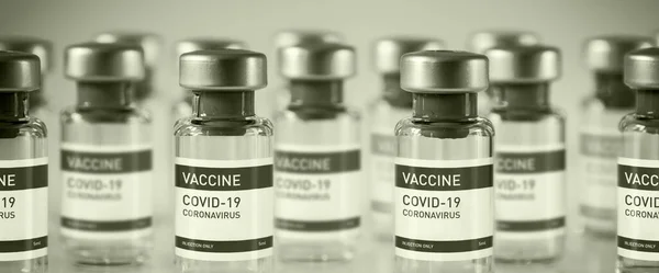 Covid-19 vaccine bottles on a black and white laboratory background - Horizontal banner