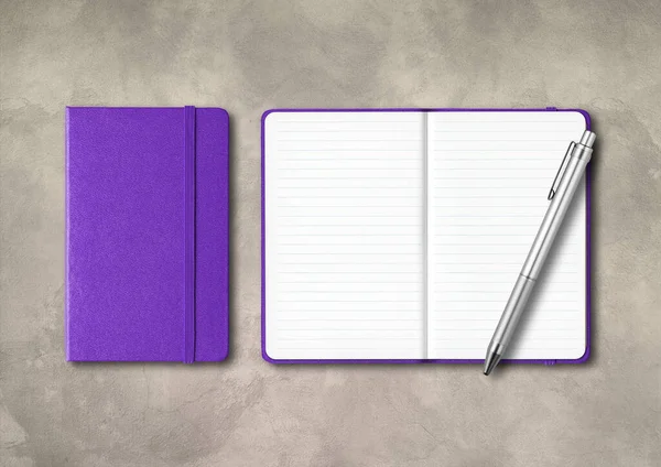 Purple closed and open lined notebooks with a pen . Mockup isolated on concrete background