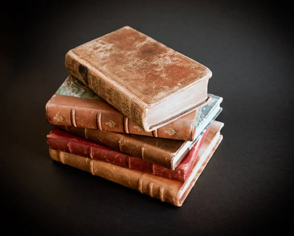 Stack of old books isolated on black background