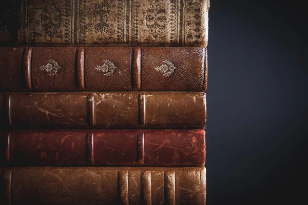 Stack of old books isolated on black background