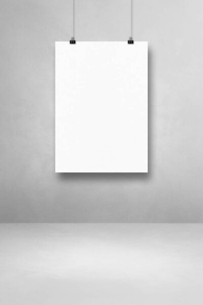 White poster hanging on a light concrete wall with clips. Blank mockup template