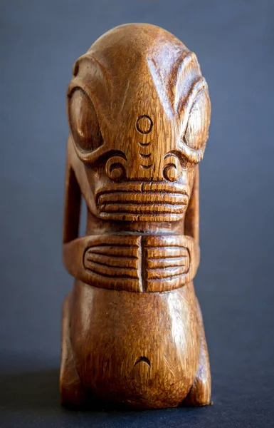 traditional wooden Polynesian tiki from Marquesas Islands. Isolated on a dark background