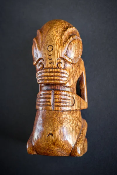 traditional wooden Polynesian tiki from Marquesas Islands. Isolated on a dark background