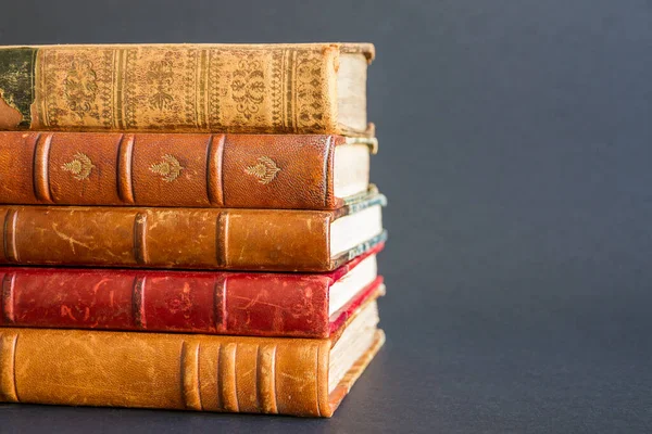 Stack of old books isolated on dark background