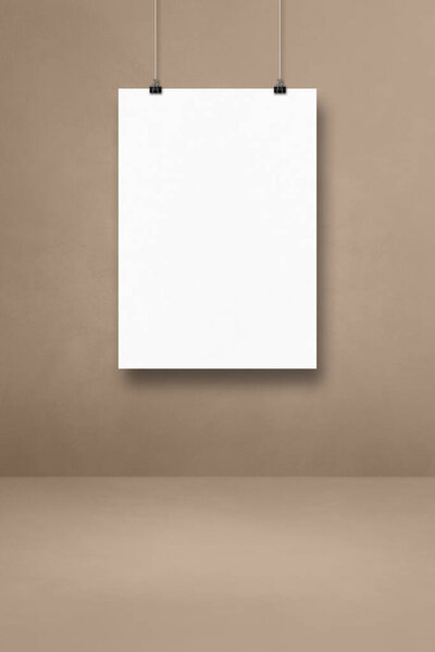 White poster hanging on a beige wall with clips. Blank mockup template