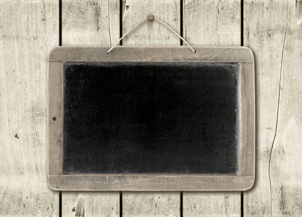 Blackboard on a white wood wall background — Stock Photo, Image