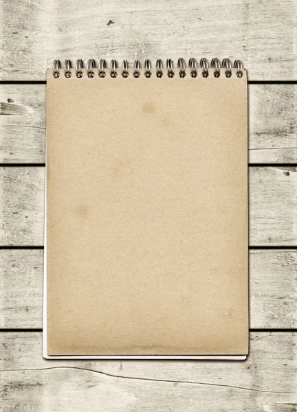 Closed spiral Note book on a white wood table — Stock Photo, Image