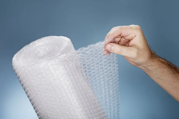 Man holding a roll of Bubble Wrap — Stock Photo, Image
