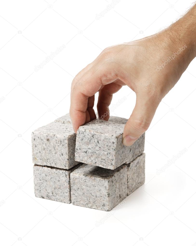Smaller cubes made of granite rock.