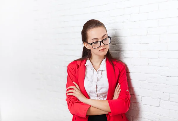 Businesswoman serious upset look down ponder wear red jacket glasses thinking — Stock Photo, Image