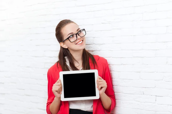 Businesswoman show tablet computer screen with empty copy space look up wear red jacket glasses happy smile — Stock Photo, Image