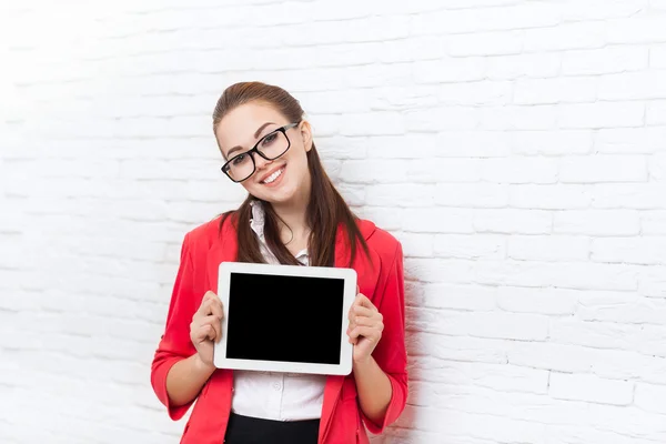 Businesswoman show tablet computer screen with empty copy space wear red jacket glasses happy smile — Stock Photo, Image