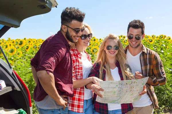 People group looking road map standing sunflowers field outdoor