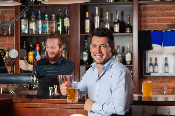 Young Man In Bar Hold Glasses Sit At Counter, Drinking Beer — Stock Fotó