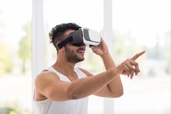 Young Hispanic Man Wear Virtual Reality Digital Glasses, Happy Smiling Guy Point Finger — Stock Photo, Image