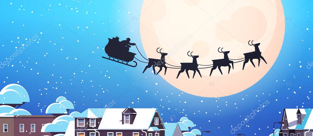 santa flying in sledge with reindeers in night sky over village houses happy new year merry christmas banner