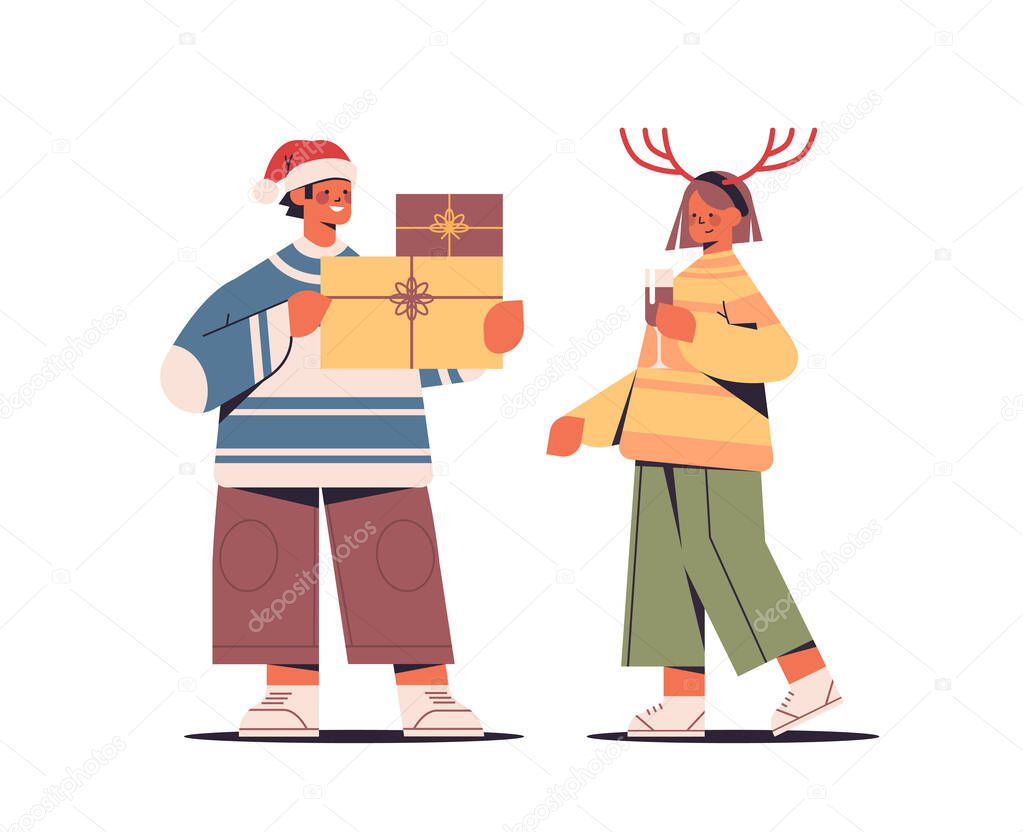 couple in santa claus hats having fun with gift boxes new year and merry christmas holidays celebration