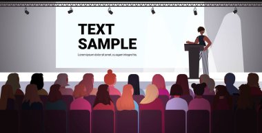Tribün Kadın Kulübü 'nden bir kadın, feminist konseptini desteklemek için seyircilere sesleniyor.