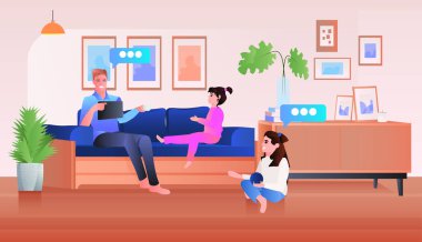 Genç baba, evde çocuklarla vakit geçiriyor. Babalık, ebeveynlik, oturma odası, iç mekan.