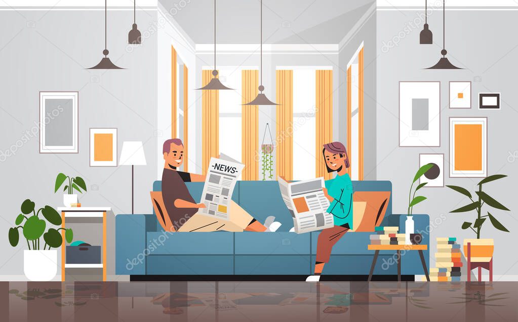 couple holding newspapers man woman sitting n sofa reading daily news press mass media concept