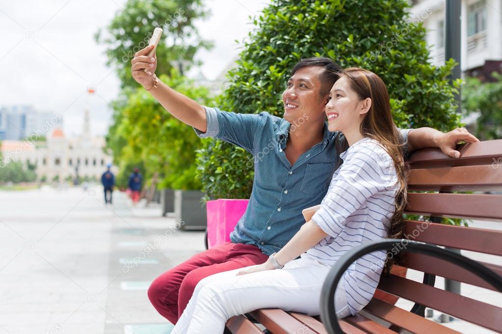 Asian couple taking selfie