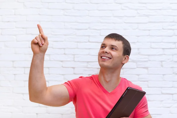 Man Point Finger Up Copy Space Holding Tablet Computer Stand Over Wall — Stock Photo, Image