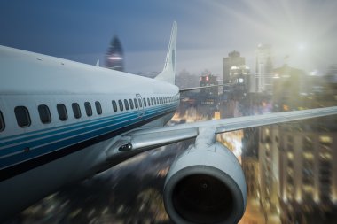 airplane fly above the city 