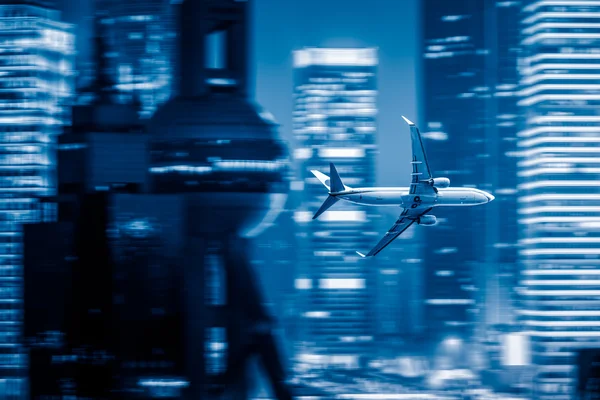 Airplane fly above the city — Stok fotoğraf