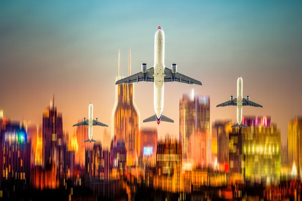 Airplane fly above the city — Stock Photo, Image