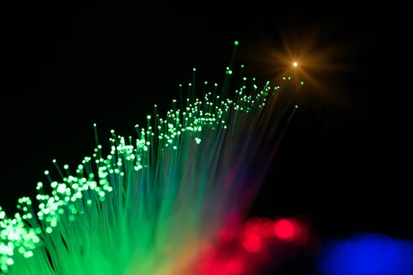 Optical fibres dinamic flying from deep on technology background — Stock Photo, Image