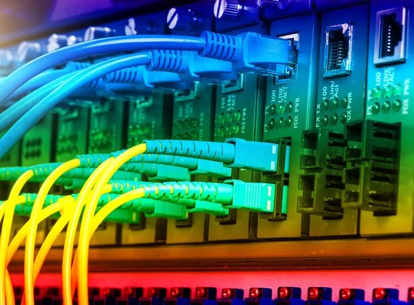 Fiber Optic cables connected to an optic ports and Network cable — Stock Photo, Image