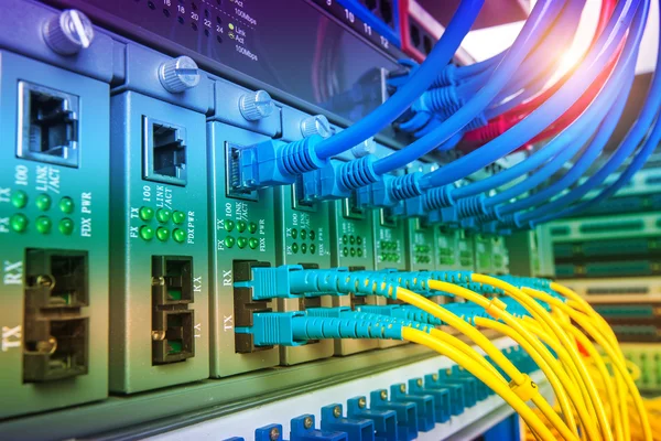 Fiber Optic cables connected to an optic ports and Network cable — Stock Photo, Image