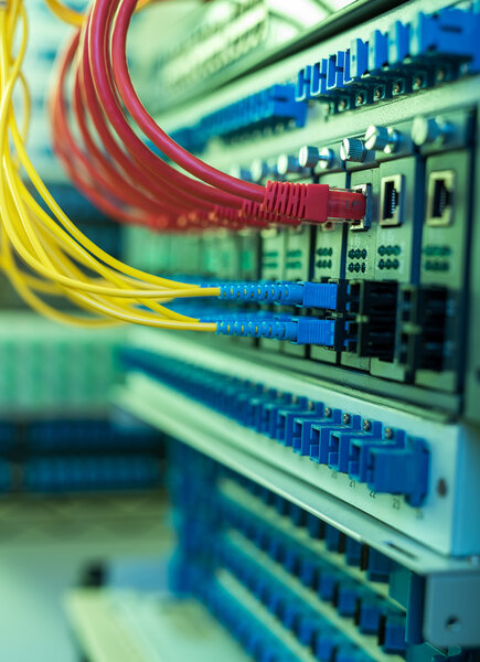 Fiber Optic cables connected to an optic ports and Network cable