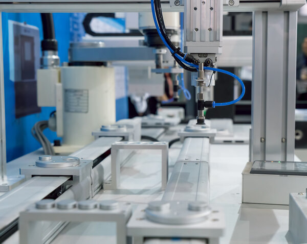 Robot arm in a factory working Stock Picture