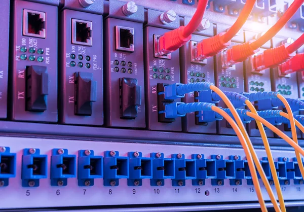 Fiber Optic cables connected to an optic ports and Network cables connected to ethernet ports