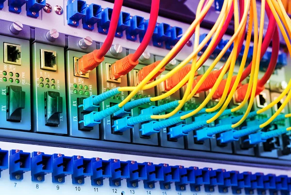 Fiber Optic cables connected to an optic ports and Network cables connected to ethernet ports