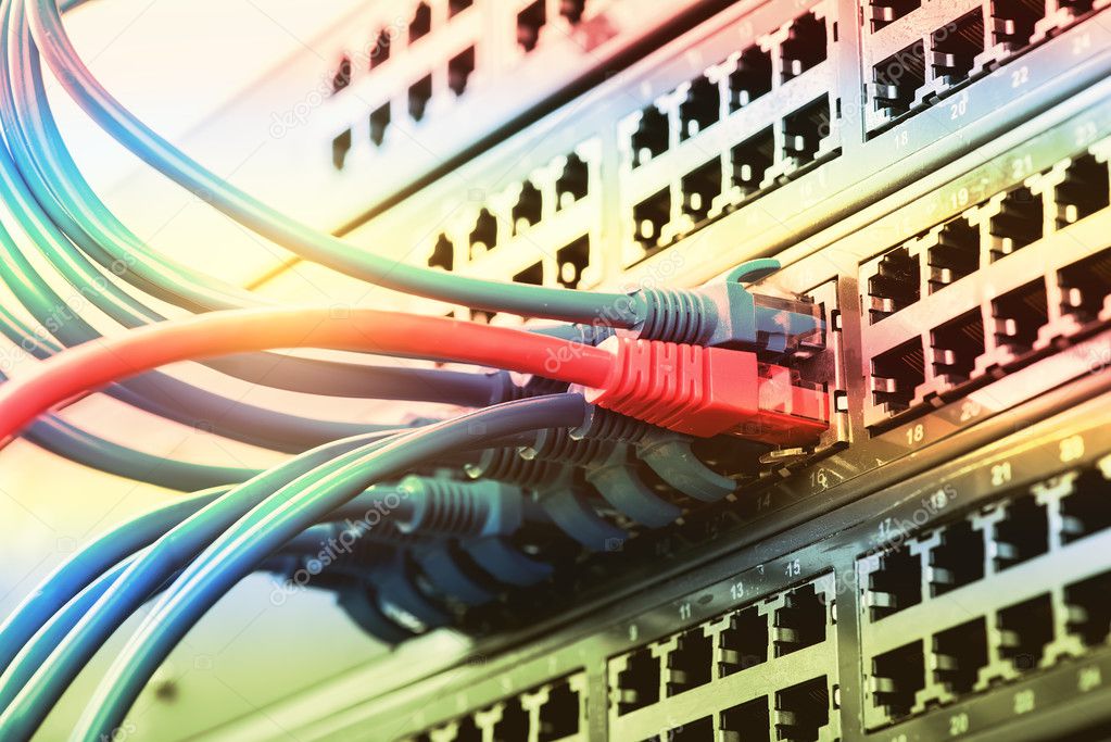 network cables and hub closeup with fiber optical background