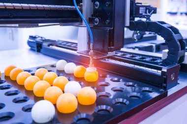 Masa tenisi topu tutmak için vakumlu robotik kol kullanımı, modern fabrika yönetimi için sanayi 4.0 teknolojisi.