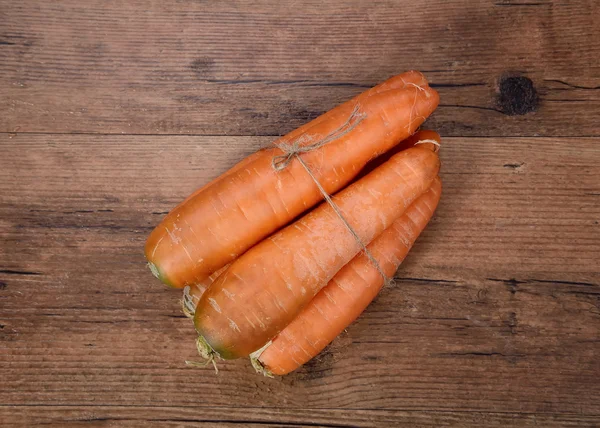 Bio-Rohkarotten aus rustikalem Holz — Stockfoto