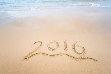 Yıl 2016 el denizin önünde beyaz kum üzerinde yazılı