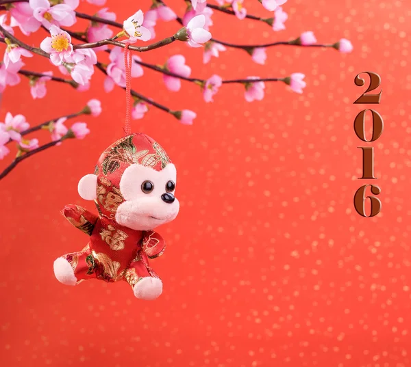 Chinese lunar new year ornaments toy of monkey on festive backgr — Stock Photo, Image