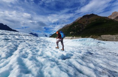 Hiker on glacier in Alaska clipart