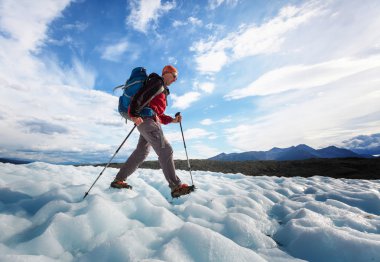 Hiker on glacier in Alaska clipart