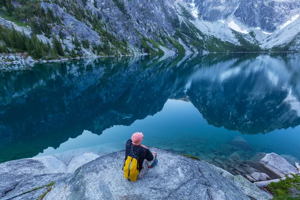 Muž sedící na jezeře — Stock fotografie
