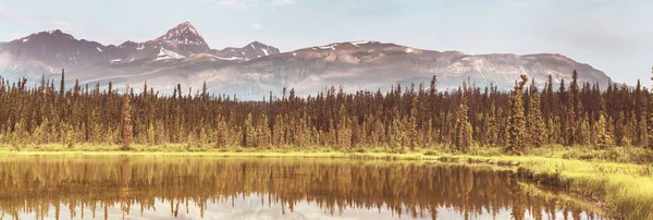 Serene scene by the mountain lake in Canada at sunset