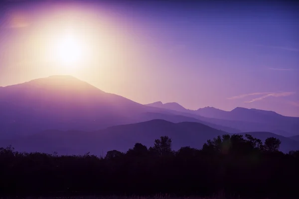 Mountains silhouette at sunrise — Stock Photo, Image