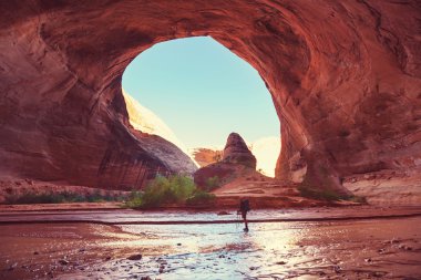 Man hiking  in Coyote gulch clipart