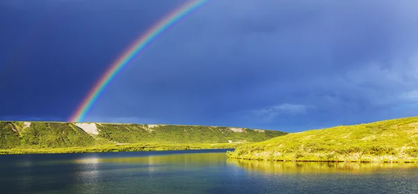 Rainbow above mountains — Stock Photo, Image