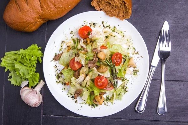 Sallad med skivat nötkött champinjoner och grönsaker — Stockfoto